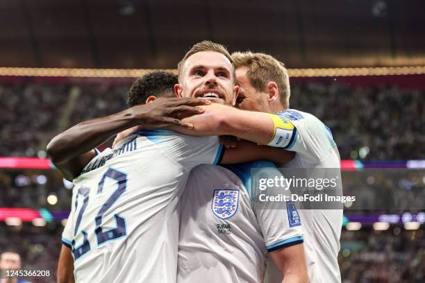 Jordan Henderson of England celebrates after scoring his team's first goal with Jude Bellingham of England and Harry Kane of England during the FIFA...