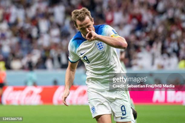 Harry Kane of England kisses his ring as he celebrates after scoring the teams second goal during the FIFA World Cup Qatar 2022 Round of 16 match...