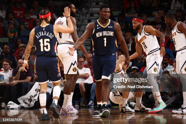 Zion Williamson of the New Orleans Pelicans high-fives teammate Jose Alvarado during the game against the Denver Nuggets on December 4, 2022 at the...