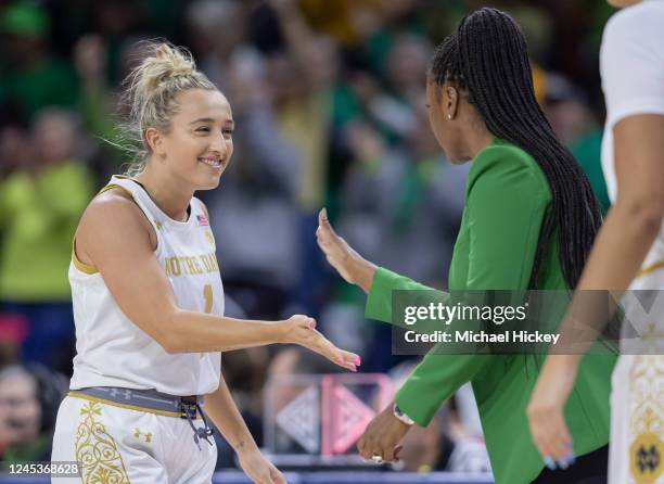 Dara Mabrey celebrates with head coach Niele Ivey of the Notre Dame Fighting Irish during the second half at Joyce Center on December 4, 2022 in...