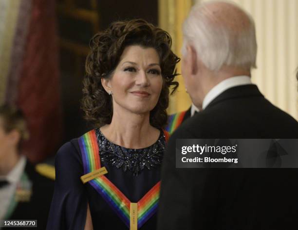 President Joe Biden, right, greets musician Amy Grant during the Kennedy Center honoree reception in the East Room of the White House in Washington,...