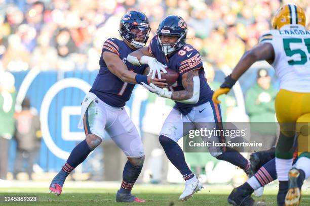 Chicago Bears quarterback Justin Fields hands the football to running back David Montgomery in action during a game between the Green Bay Packers and...