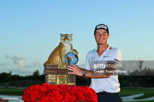 Two-time champion, Viktor Hovland of Norway poses with the trophy after the final round, during the trophy ceremony, of the Hero World Challenge at...