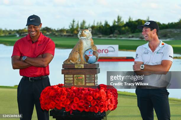 Two-time champion, Viktor Hovland of Norway laughs with the only other two-time champion of this event, Tiger Woods, during the trophy ceremony after...