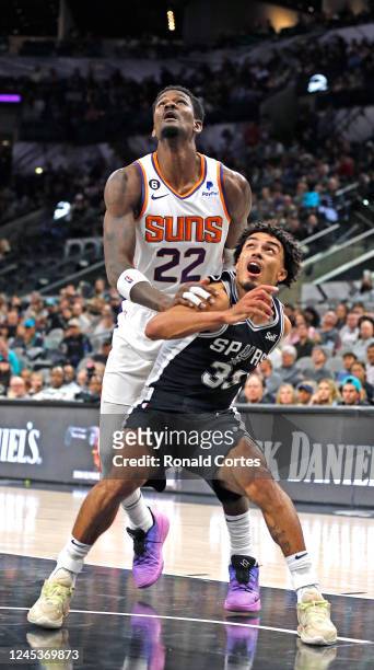 Tre Jones of the San Antonio Spurs blocks Deandre Ayton of the Phoenix Suns in the second half of the game at AT&T Center on December 4, 2022 in San...