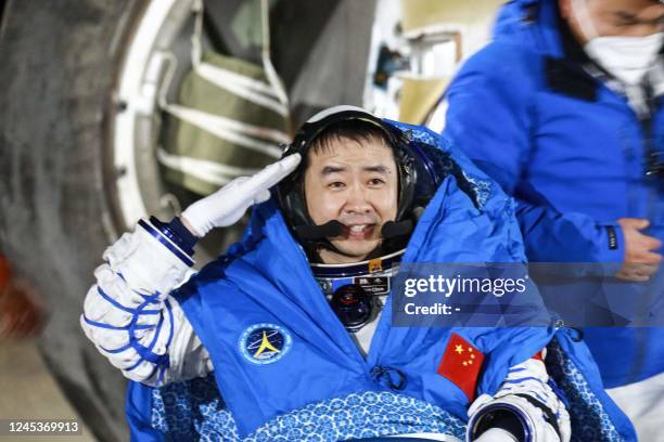 This photo taken on December 4, 2022 shows Chinese astronaut Chen Dong saluting as he leaves the capsule of the Shenzhou-14 spacecraft after landing...