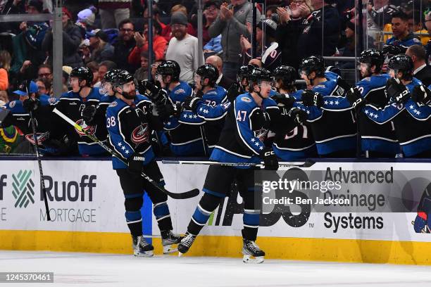 Marcus Bjork of the Columbus Blue Jackets celebrates with teammates after scoring a goal during the second period of a game against the Detroit Red...