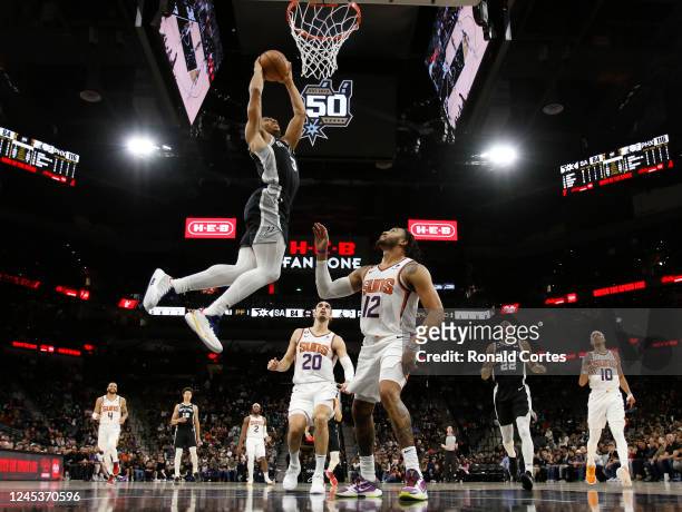 Keldon Johnson of the San Antonio Spurs dunks past Ish Wainright of the Phoenix Suns in the second half of the game at AT&T Center on December 4,...