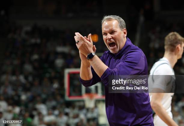Head coach Chris Collins of the Northwestern Wildcats celebrates in the first half of the game against the Michigan State Spartans at Breslin Center...
