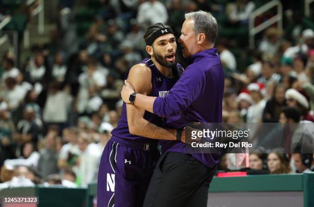 Head coach Chris Collins of the Northwestern Wildcats celebrates with Boo Buie of the Northwestern Wildcats in the second half of the game against...