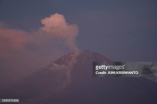 Smoke rises from Mount Semeru in Lumajang on December 5, 2022. - Indonesia's Mount Semeru erupted on December 4 spewing hot ash clouds a mile high...