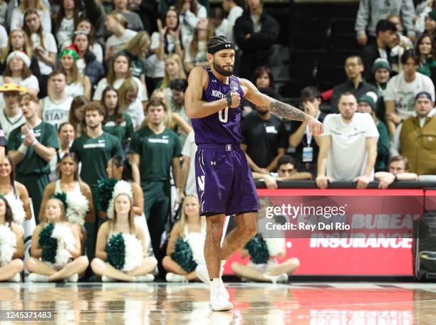 Boo Buie of the Northwestern Wildcats celebrates late in the second half of the game against the Michigan State Spartans at Breslin Center on...