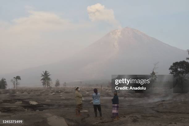 People are seen as Mount Semeru continues to spew volcanic ash after its eruption yesterday in Lumajang Regency, Indonesia on December 5, 2022....