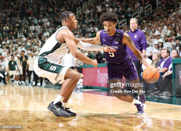 Julian Roper II of the Northwestern Wildcats drives against Pierre Brooks of the Michigan State Spartans in the second half of the game at Breslin...