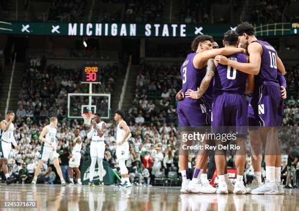 Ty Berry, Boo Buie, Tydus Verhoeven, Chase Audige of the Northwestern Wildcats takes the court before the start of the game against the Michigan...