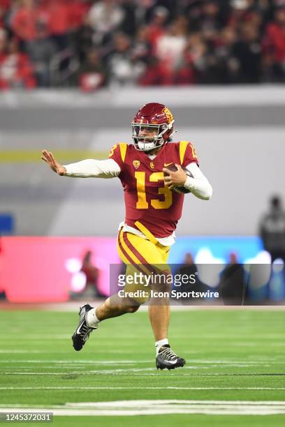 Trojans quarterback Caleb Williams runs up field, looking like he was making a Heisman pose, during the Pac-12 Conference championship game between...