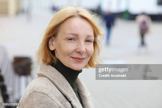outdoors portrait of a 45 year old red-haired woman - northern european descent stock pictures, royalty-free photos & images