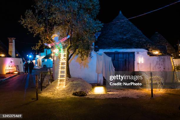 Characters of the nativity scene of light in the Aia Piccola district among the trulli of Alberobello, on the occasion of the Christmas holidays on...