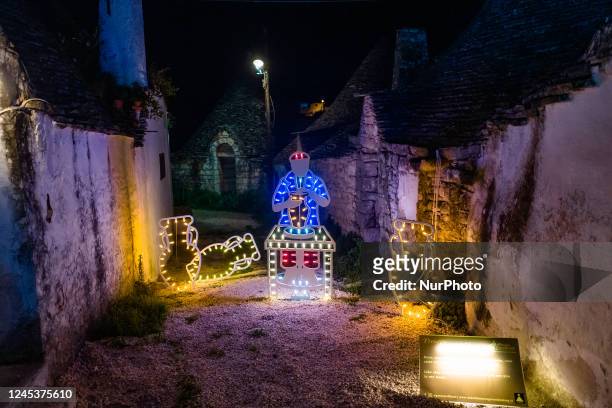 Characters of the nativity scene of light in the Aia Piccola district among the trulli of Alberobello, on the occasion of the Christmas holidays on...