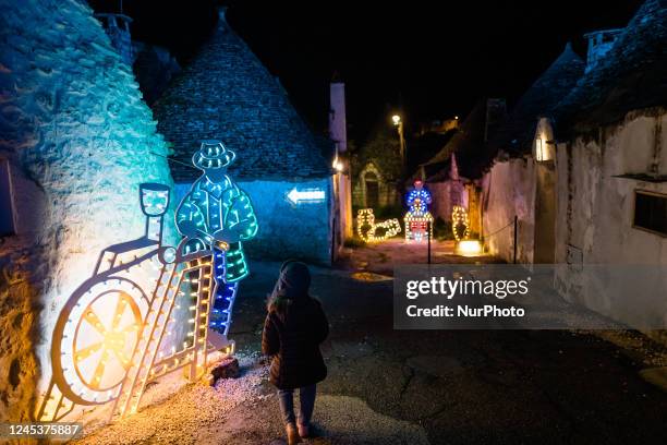 Characters of the nativity scene of light in the Aia Piccola district among the trulli of Alberobello, on the occasion of the Christmas holidays on...