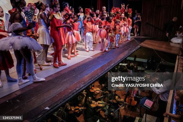 Dancers of the Dance Centre Kenya and members of the Nairobi Philharmonic Orchestra react after the final stage of The Nutcracker, a ballet primarily...