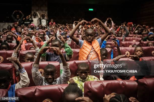 About 500 invited children from the Kibera slum learn posing as they watch The Nutcracker, a ballet primarily performed during the Christmas period,...