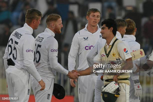 England's captain Ben Stokes shakes hands with Pakistan's Naseem Shah after their victory at the end of the fifth and final day of the first cricket...