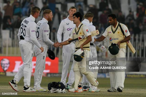 England's captain Ben Stokes shakes hands with Pakistan's Naseem Shah after their victory at the end of the fifth and final day of the first cricket...