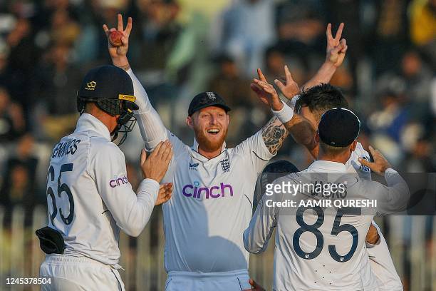 England's Ben Stokes celebrates with teammates after the dismissal of Pakistan's Haris Rauf during the fifth and final day of the first cricket Test...