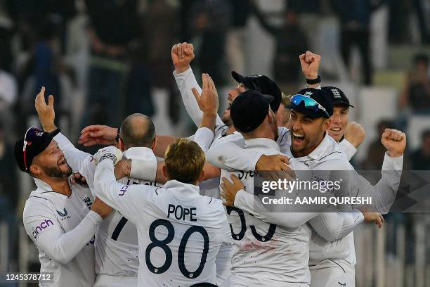 England's players celebrates after their victory at the end of the fifth and final day of the first cricket Test match between Pakistan and England...