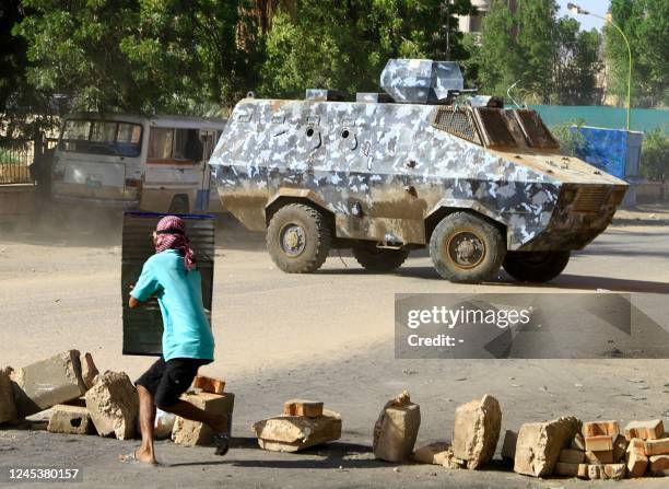 Demonstrator takes cover behind a makeshift shield during clashes with security forces amidst a mass demonstration in the area of Bashdar in the...