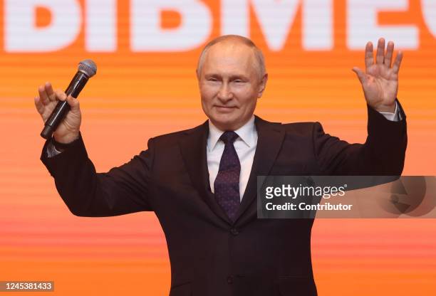 Russian President Vladimir Putin waves during the awarding ceremony at the We Are Toghether Youth Forum, on December 5, 2022 in Moscow, Russia....