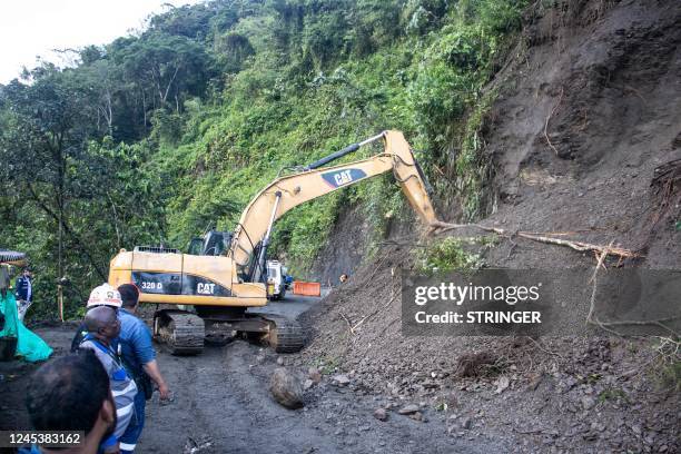 Rescue teams use heavy equipment to remove soil after a mountain landslide in the sector El Ruso, Pueblo Rico municipality, in northwestern Bogota,...