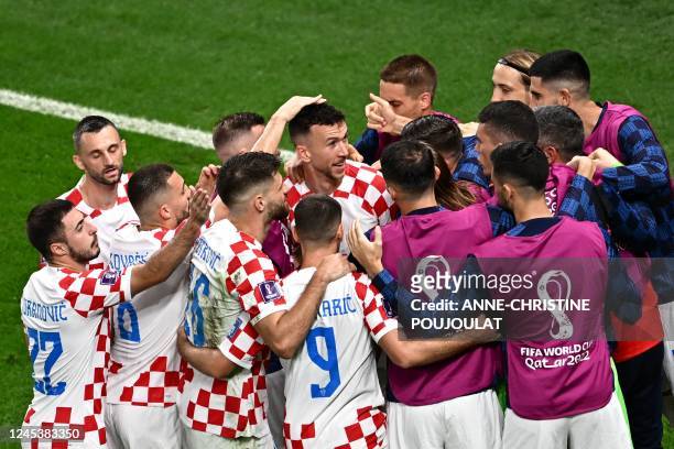 Croatia's players celebrate after their team scored first goal during the Qatar 2022 World Cup round of 16 football match between Japan and Croatia...