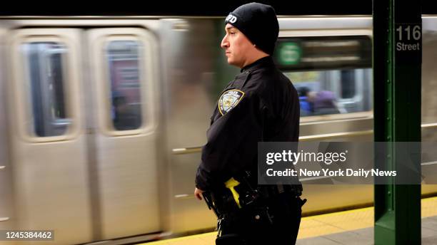 An NYPD Officer is seen at the platform at 116th Street and Lexington Avenue Subway station in New York City.