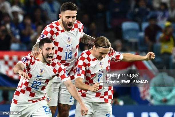 Croatia's defender Josip Juranovic, Croatia's forward Marko Livaja and Croatia's midfielder Lovro Majer celebrate winning after penalty shoot-out the...