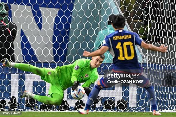Croatia's goalkeeper Dominik Livakovic saves the penalty of Japan's midfielder Takumi Minamino during the Qatar 2022 World Cup round of 16 football...