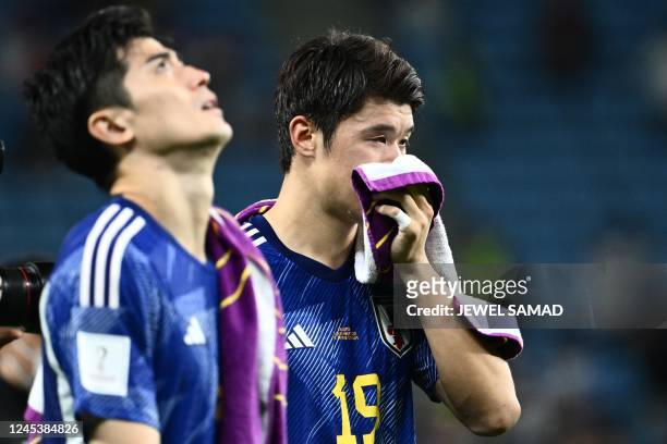 Japan's defender Hiroki Sakai reacts after his team lost the Qatar 2022 World Cup round of 16 football match between Japan and Croatia at the...