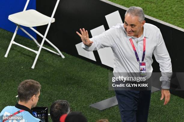 Brazil's coach Tite waves to fans ahead of the Qatar 2022 World Cup round of 16 football match between Brazil and South Korea at Stadium 974 in Doha...