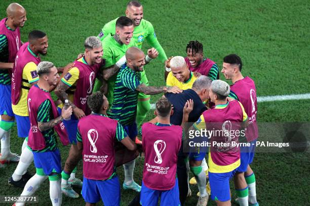 Brazil's Richarlison celebrates scoring their side's third goal of the game with manager Tite and players during the FIFA World Cup Round of Sixteen...