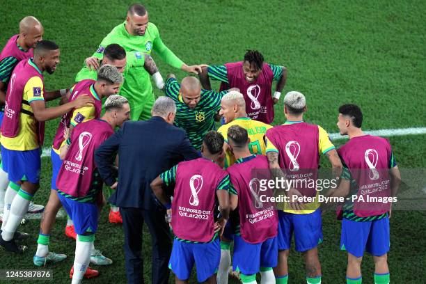 Brazil's Richarlison celebrates scoring their side's third goal of the game with manager Tite and players during the FIFA World Cup Round of Sixteen...