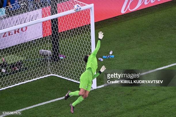 Brazil's goalkeeper Alisson makes a save during the Qatar 2022 World Cup round of 16 football match between Brazil and South Korea at Stadium 974 in...
