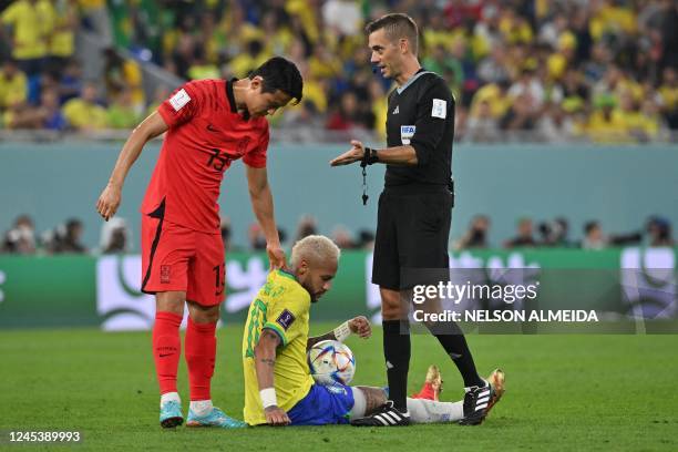 French referee Clement Turpin gestures after Brazil's forward Neymar was fouled by South Korea's midfielder Son Jun-ho during the Qatar 2022 World...
