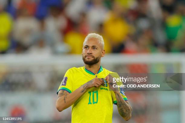 Brazil's forward Neymar celebrates after his team won the Qatar 2022 World Cup round of 16 football match between Brazil and South Korea at Stadium...