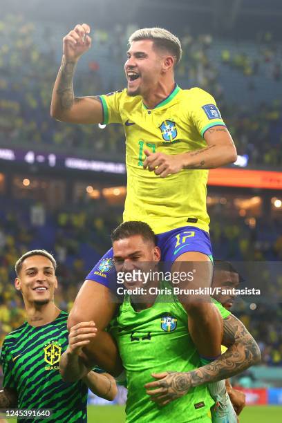 Bruno Guimaraes of Brazil celebrates with Ederson at the end of the FIFA World Cup Qatar 2022 Round of 16 match between Brazil and South Korea at...