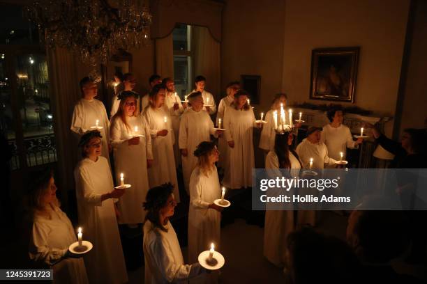 Members of the London Nordic Choir lead a Lucia procession at the Swedish Ambassador's Residence on December 5, 2022 in the Marylebone area of...