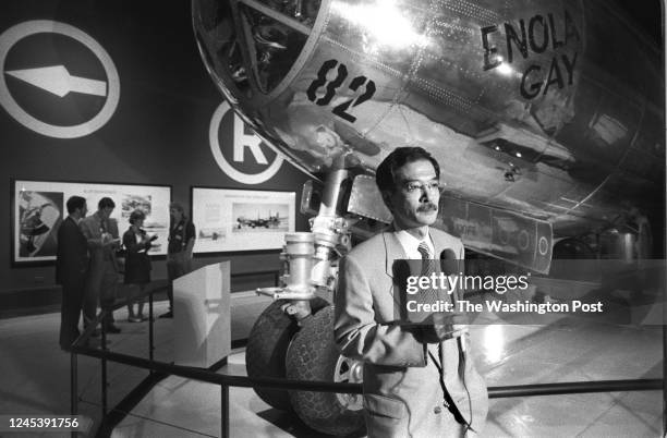 Japanese reporter Seltaro files his story from in front of the Enola Gay at the National Air and Space Museum, on June 28 in Washington, DC. The...