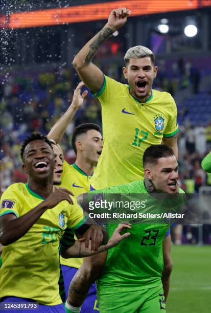 Vinicius Junior, Bruno Guimaraes and Ederson, Goalkeeper of Brazil celebrating after the FIFA World Cup Qatar 2022 Round of 16 match between Brazil...