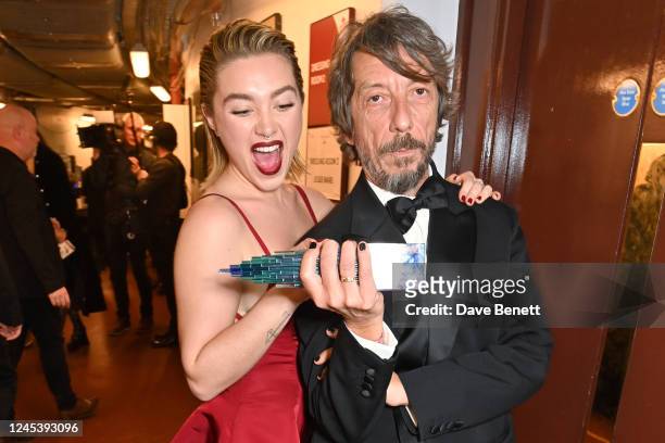 Florence Pugh and Valentino Creative Director Pierpaolo Piccioli, winner of the Designer of the Year Award, pose backstage at The Fashion Awards 2022...