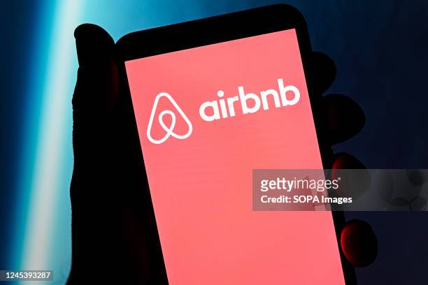 In this photo illustration an Airbnb logo seen displayed on a smartphone.